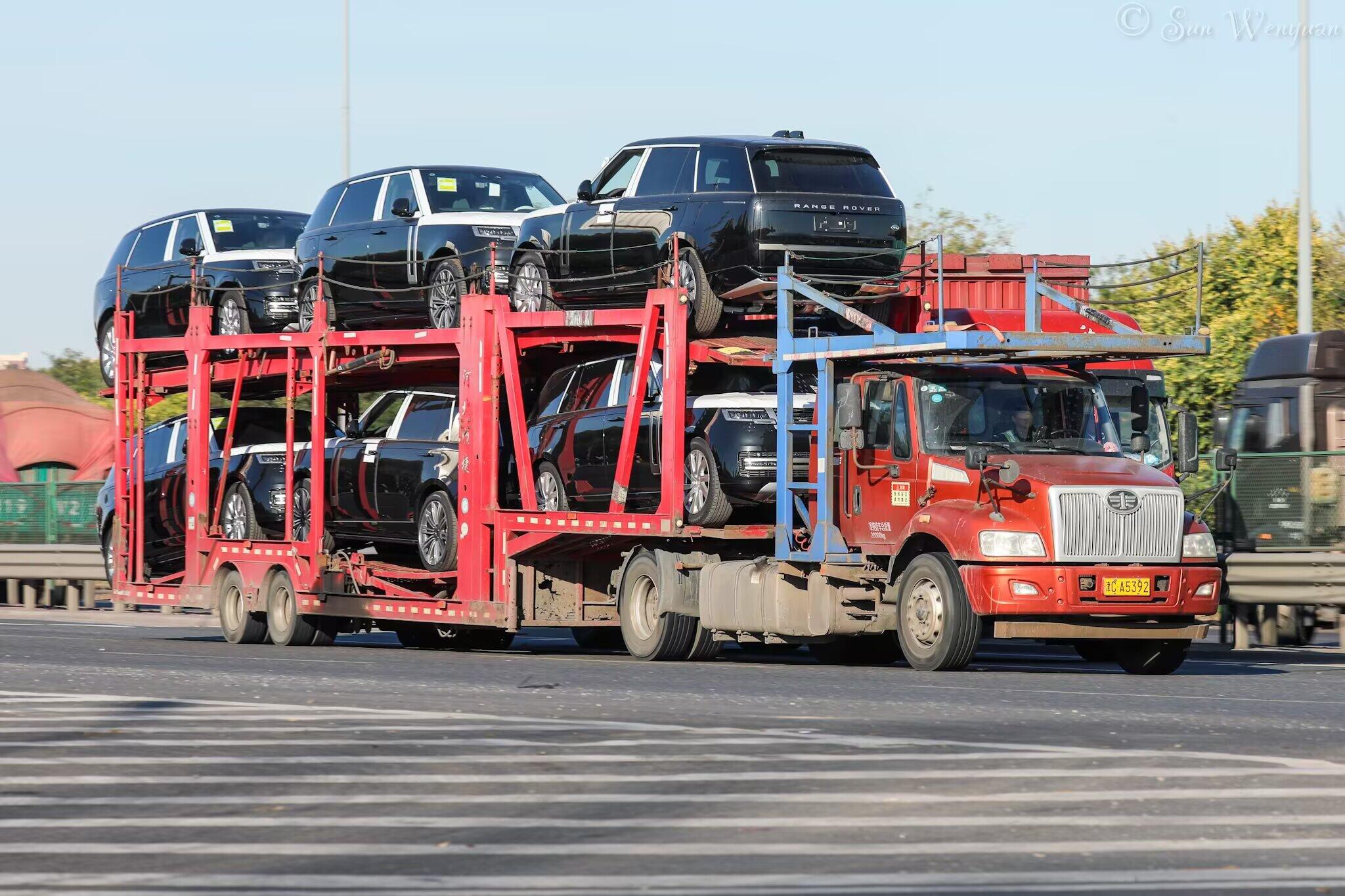 Car carrier loaded with SUVs departing for the port