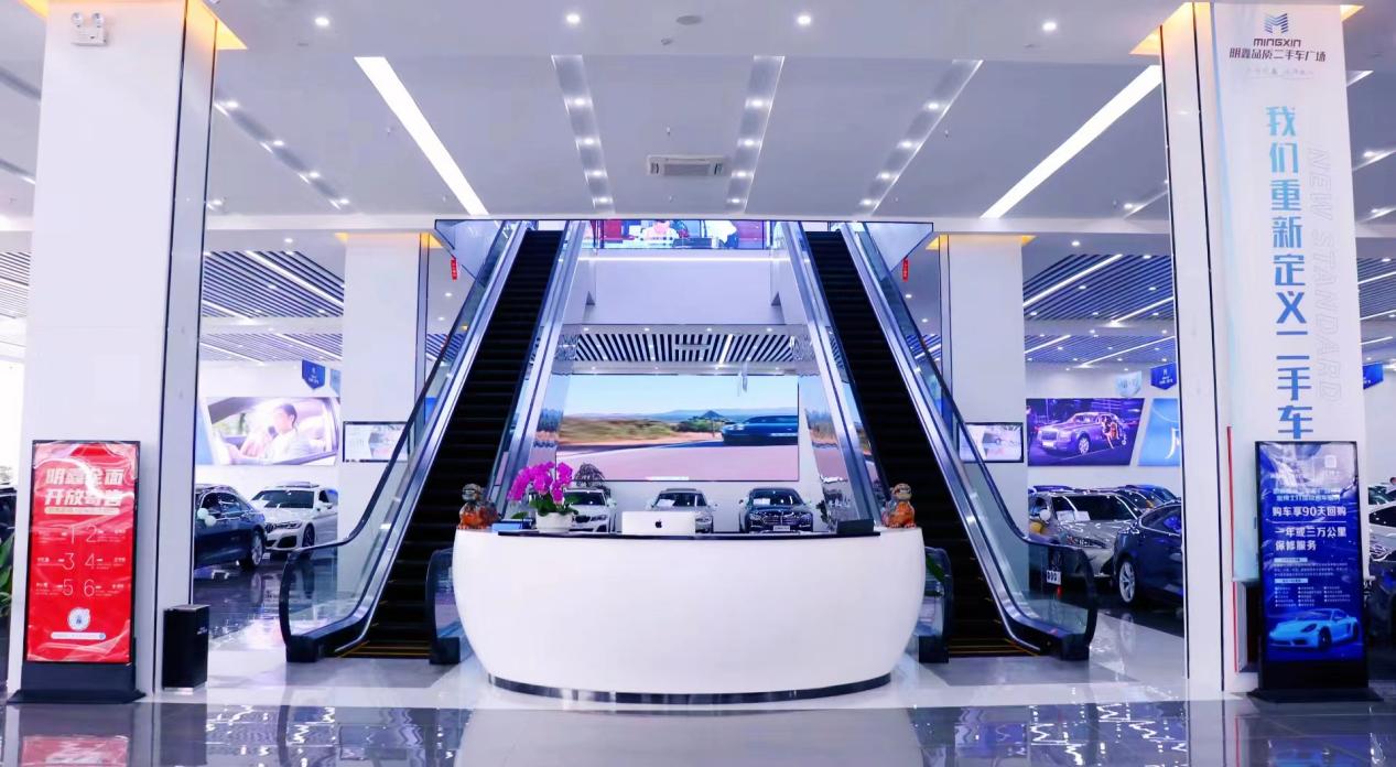 Main showroom atrium with escalator and reception desk